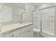 Bathroom with granite countertop, white cabinets, and shower at 1819 Capstone Dr, Durham, NC 27713