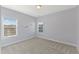 Light purple bedroom with neutral carpet and two windows at 1819 Capstone Dr, Durham, NC 27713
