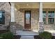 Inviting front entrance with a wood door and brick facade at 1819 Capstone Dr, Durham, NC 27713