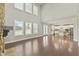 Open Gathering room with hardwood floors and a stone fireplace at 1819 Capstone Dr, Durham, NC 27713