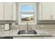 Kitchen sink with stainless steel faucet and view to backyard at 1819 Capstone Dr, Durham, NC 27713