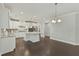 Eat-in kitchen with island, granite countertops, and white cabinets at 1819 Capstone Dr, Durham, NC 27713