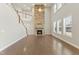 Spacious living room featuring a large stone fireplace and hardwood floors at 1819 Capstone Dr, Durham, NC 27713