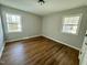 Spacious bedroom with hardwood floors and large windows at 209 Carolyn Dr, Benson, NC 27504