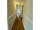 Clean and bright hallway with new flooring and neutral color palette at 209 Carolyn Dr, Benson, NC 27504