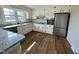 Renovated kitchen boasts granite countertops and stainless steel appliances at 209 Carolyn Dr, Benson, NC 27504