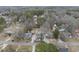 An aerial view shows several homes on spacious lots near a road, highlighting the neighborhood's layout and curb appeal at 210 W Oak Ave, Wake Forest, NC 27587