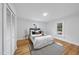 Bright bedroom features hardwood floors, modern rug, and neutral decor at 210 W Oak Ave, Wake Forest, NC 27587