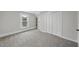 Sunlit bedroom offers neutral walls, updated carpet, and built-in shelving at 210 W Oak Ave, Wake Forest, NC 27587