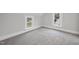 Bedroom with gray carpeting, modern windows and bright lighting at 210 W Oak Ave, Wake Forest, NC 27587