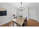 Bright dining room with modern lighting and decor, adjacent to the kitchen at 210 W Oak Ave, Wake Forest, NC 27587
