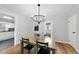 Dining room with hardwood floors, a modern chandelier, and a view into the kitchen at 210 W Oak Ave, Wake Forest, NC 27587