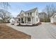 Two-story home featuring landscaping, a gravel driveway, and a charming covered porch at 210 W Oak Ave, Wake Forest, NC 27587