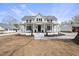 Charming two-story farmhouse-style home with a covered front porch and classic black shutters at 210 W Oak Ave, Wake Forest, NC 27587