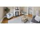 Comfortable living room with fireplace, hardwood floors, area rug and stylish furnishings at 210 W Oak Ave, Wake Forest, NC 27587