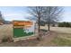 Welcome to E. Carroll Joyner Park sign with stone surround at 210 W Oak Ave, Wake Forest, NC 27587