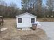 Exterior view of a white shed with black trim and a gravel surrounding in the backyard at 210 W Oak Ave, Wake Forest, NC 27587