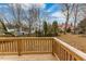Backyard view featuring a wooden deck and surrounding trees at 211 Long Ave, Graham, NC 27253