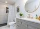 Modern bathroom features a vanity with a stone countertop and tiled shower at 211 Long Ave, Graham, NC 27253