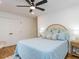Bedroom showcasing a ceiling fan, wood floors, and ample natural light at 211 Long Ave, Graham, NC 27253