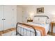 Bedroom featuring hardwood floors, a metal bed frame, and neutral decor at 211 Long Ave, Graham, NC 27253