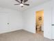 Bedroom leading into bathroom with neutral carpet, closet, and natural light at 211 Long Ave, Graham, NC 27253