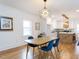 Stylish dining area with modern lighting, seating for four, and an open view to the kitchen at 211 Long Ave, Graham, NC 27253