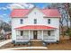 Two-story home with red roof, white siding, and front porch at 211 Long Ave, Graham, NC 27253