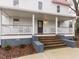 Charming front porch with rocking chairs and brick stairs leading to the front door at 211 Long Ave, Graham, NC 27253
