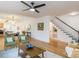 Bright, open-concept living room featuring hardwood floors, modern furnishings, and seamless flow to dining and kitchen at 211 Long Ave, Graham, NC 27253