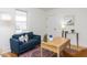 Cozy living room with a comfortable sofa, natural light, and a stylish rug at 211 Long Ave, Graham, NC 27253