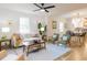 Open-concept living area with hardwood floors, neutral décor, and seamless flow to the dining and kitchen at 211 Long Ave, Graham, NC 27253