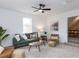 Comfortable living room features a green sofa, natural decor, and a ceiling fan at 211 Long Ave, Graham, NC 27253