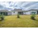 Manicured backyard featuring a well maintained lawn, young trees, and a view of the house and screened-in porch at 212 War Admiral Dr, Clayton, NC 27520