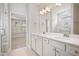 Bathroom featuring white cabinets and double vanity sinks and access to the bedroom at 212 War Admiral Dr, Clayton, NC 27520