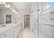 Bathroom featuring white cabinets, double vanity sinks, and a glass enclosed shower at 212 War Admiral Dr, Clayton, NC 27520