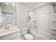Bright bathroom with white vanity, tiled floors, and a shower-tub combo with colorful curtain at 212 War Admiral Dr, Clayton, NC 27520