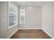 A simple and neat bedroom featuring hardwood floors and ample natural light through two windows at 212 War Admiral Dr, Clayton, NC 27520
