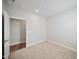 A neutral-colored room with carpet and trim and an adjoining room featuring wood-look flooring at 212 War Admiral Dr, Clayton, NC 27520