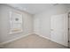 This bedroom features neutral carpet, ample natural light from the window, and neutral-colored walls at 212 War Admiral Dr, Clayton, NC 27520