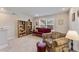 Cozy bonus room features a futon, armchair, and built-in shelving at 212 War Admiral Dr, Clayton, NC 27520