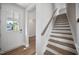 Welcoming entryway with hardwood floors, a staircase, and a front door with glass panels at 212 War Admiral Dr, Clayton, NC 27520
