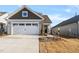 Two-story Craftsman style home with a two car garage and landscaped front yard at 212 War Admiral Dr, Clayton, NC 27520