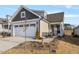 Two-story Craftsman style home with a two car garage and landscaped front yard at 212 War Admiral Dr, Clayton, NC 27520