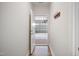 Hallway with wood-look flooring and a door to the garage with coat hooks nearby at 212 War Admiral Dr, Clayton, NC 27520