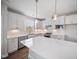 Spacious kitchen with white cabinets, granite countertops, and modern stainless steel appliances at 212 War Admiral Dr, Clayton, NC 27520