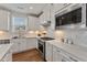 Modern kitchen with white cabinets, quartz countertops, and stainless steel appliances at 212 War Admiral Dr, Clayton, NC 27520
