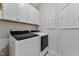 Laundry room with washer, dryer, and overhead cabinets at 212 War Admiral Dr, Clayton, NC 27520
