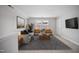 Upstairs living area with neutral carpet, grey sofa, and a large rug at 212 War Admiral Dr, Clayton, NC 27520