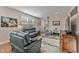 Living room with leather sofas, hardwood floors, and large windows at 212 War Admiral Dr, Clayton, NC 27520